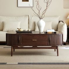 a living room with white couches and a coffee table in front of the couch