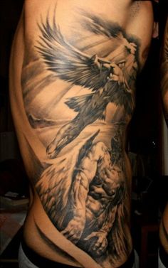 a man's back with an eagle and demon tattoo on his side, in black and white