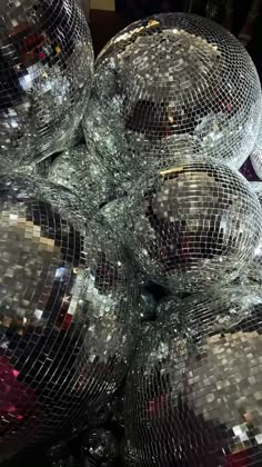 many shiny disco balls are stacked on top of each other