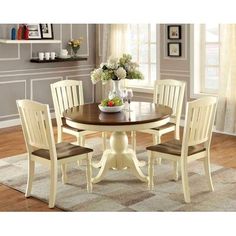 a dining room table with four chairs around it