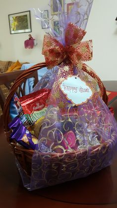 a basket filled with chocolates and candies sitting on top of a wooden table