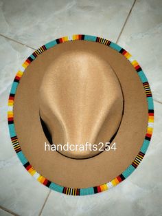 This is a beaded fedora hat. It's an adult size hat in the Lumbee tribe colors. Handmade Multicolor Southwestern Hats, Handmade Southwestern Multicolor Hats, Beaded Brim Hat, Bohemian Beaded Turquoise Hat, Turquoise Beaded Bohemian Hat, Handmade Turquoise Hat, One Size Fits Most, Handmade Fedora For Beach Costume, Handmade Fedora For Festival, Turquoise Beaded Beach Hat