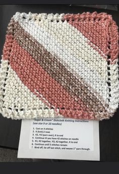 a crochet dishcloth with instructions on the front and side, sitting on top of a table