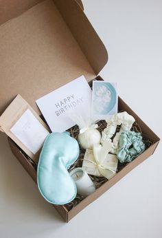 a birthday gift box filled with cake and decorations