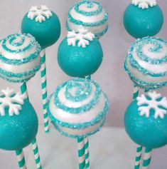 blue and white cake pops with snowflakes on them