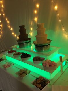 three tiered trays filled with different types of donuts on top of a table