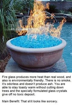 a fire pit with blue glass in the middle and flames coming out of it on top