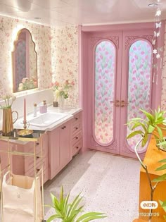 the bathroom is decorated in pink and has two double doors that lead out to another room