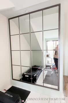 a mirror that is in the middle of a room with suitcases on top of it