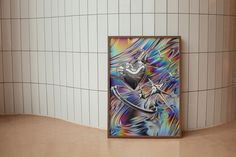 an abstract painting on the wall next to a tiled wall in a public restroom with white tiles