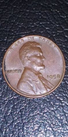 a close up of a penny on a leather surface