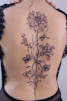 a woman's back with flowers on it