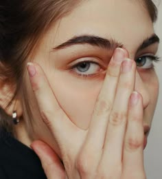 a woman covering her face with both hands