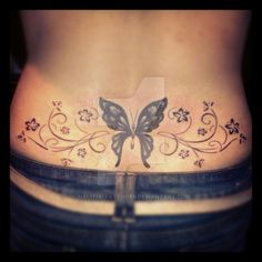 a woman's stomach with a butterfly tattoo on the bottom part of her belly