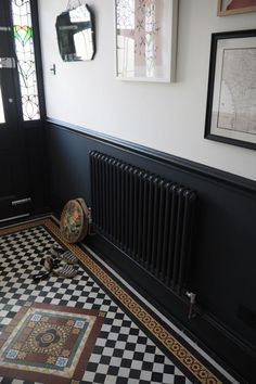 a black and white checkered floor with a radiator in the corner next to it