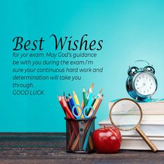 an alarm clock, pencils and books on a table with the words best wishes