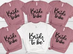 the bride tribe shirts are pink and white with black lettering on them, along with matching t - shirts