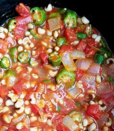 corn, tomatoes and peppers are mixed together in the slow cooker to make an entree