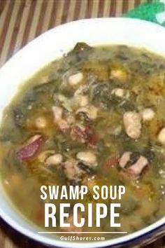 a white bowl filled with soup sitting on top of a table next to a green napkin