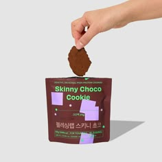 a bag of skinnyy choco cookie is being held up