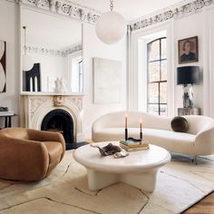 a living room filled with furniture and a fire place