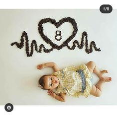 a baby is laying on the floor in front of a sign that says mr and mrs