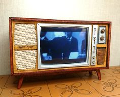 an old fashioned television sitting on top of a table