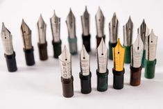 several fountain pens lined up in different colors