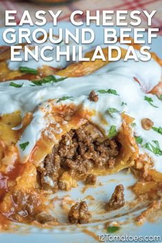 easy cheesy ground beef enchiladas on a plate with sour cream