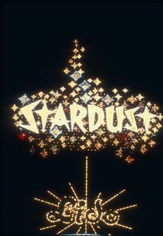 the stardust sign is lit up at night