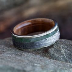 a wooden ring sitting on top of a rock