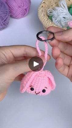 someone is holding a crocheted keychain with a pink bunny on it