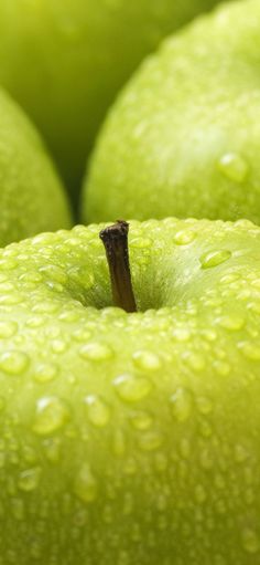 green apples with drops of water on them