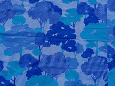 a blue and white fabric with flowers on it