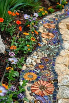 a garden with flowers and rocks on the ground