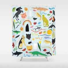 a shower curtain with animals and other things on the shower mat, all in different colors