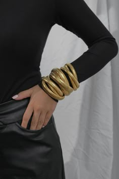 A chunky and bold look is signature to the tubogas cobra braceletis the vintage style we all fell in love withThe metallic trinity symbols for boldness and powerA bold and oversized statement piecethe cobra bracelet is crafted in a heavyweight chunky styleOur cobra bracelet has a touch of vintage funk and adds haziness to high fashion statement jewelryThis bracelet is the perfect blend of contemporary styling and traditional charmPair it with any accessories to create a cohesive lookelastic ban Maximalist Jewelry Bracelets, Chunky Gold Bangle, Statement Accessories Outfit, Chunky Gold Accessories, Chunky Gold Bangles, Gold Chunky Bracelets, Trending Bracelets 2024, Gold Chunky Jewelry, Chunky Jewelry Aesthetic