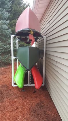 there is a rack with several different items on it outside the house and some trees in the background