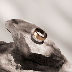 a gold ring sitting on top of a rock