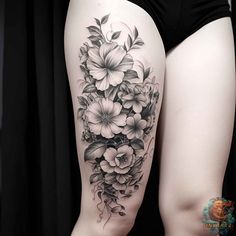 a woman's thigh with flowers and leaves on her thighs, in black and white