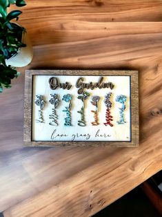 a wooden sign that says our garden is five years old on the table next to a potted plant