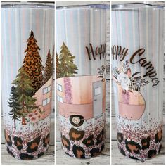 three tumbles with the words happy camper painted on them and decorated with trees