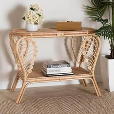 a wicker table with some books and a plant on it next to a potted plant