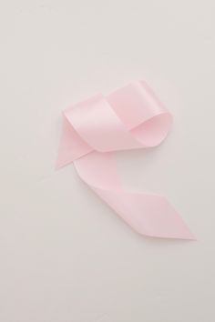 a pink ribbon on a white background