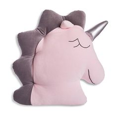 a pink and grey unicorn pillow with a silver horn on it's head, sitting against a white background