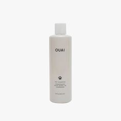 a bottle of ouai shampoo on a white background