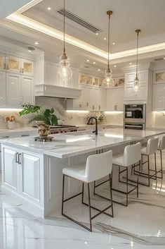 a large kitchen with white cabinets and marble counter tops, along with bar stools