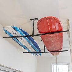 two surfboards are hanging from the ceiling