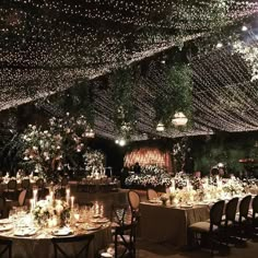 the tables are set with candles, flowers and greenery for an elegant wedding reception