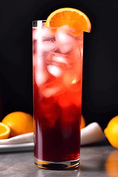 a tall glass filled with ice and an orange slice